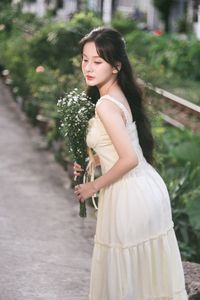 Serene Natural Beauty: Gentle Girl in Cream Dress Amidst Lush Garden-4