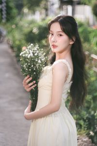Serene Natural Beauty: Gentle Girl in Cream Dress Amidst Lush Garden-3