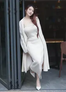 Discover the elegant charm of a gentle woman captured in a serene, thoughtful moment 176403855-4