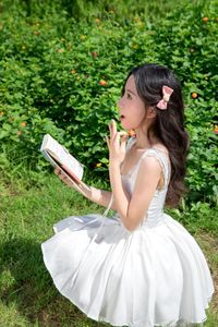 Elegant Young Woman in White Dress Amidst Greenery | Natural Summer Beauty-2