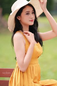 Charming Girl in Yellow Dress with Wide-Brim Hat Outdoors-2