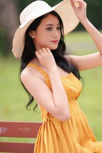 Charming Girl in Yellow Dress with Wide-Brim Hat Outdoors-5