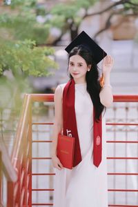 Beautiful Female Graduate Embraces Success at Graduation Ceremony-1