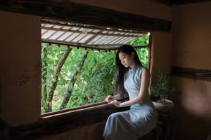 XVG No.43: Discover the captivating elegance of an Asian young woman in a pensive moment by the window.-3