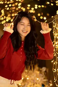 Radiant Smile Girl in Red Amidst Twinkling Lights: Warm Beauty for Festive Season-2