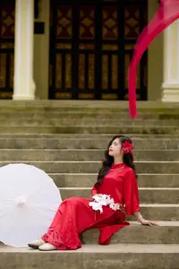 Graceful Vietnamese Beauty: Traditional Ao Dai Adorned with a Vibrant Red Flower-1