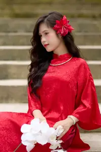 Graceful Vietnamese Beauty: Traditional Ao Dai Adorned with a Vibrant Red Flower-11