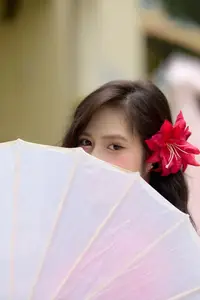 Graceful Vietnamese Beauty: Traditional Ao Dai Adorned with a Vibrant Red Flower-17