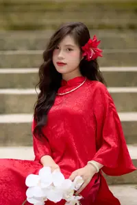 Graceful Vietnamese Beauty: Traditional Ao Dai Adorned with a Vibrant Red Flower-12
