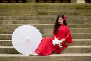 Graceful Vietnamese Beauty: Traditional Ao Dai Adorned with a Vibrant Red Flower-13