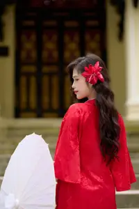 Graceful Vietnamese Beauty: Traditional Ao Dai Adorned with a Vibrant Red Flower-16