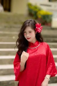 Graceful Vietnamese Beauty: Traditional Ao Dai Adorned with a Vibrant Red Flower-4