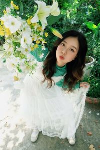 Captivating Smile: Young Woman in Green Embraces Nature's Serenity 1000019864-0