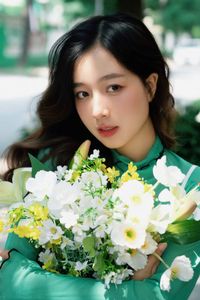 Captivating Smile: Young Woman in Green Embraces Nature's Serenity 1000019864-8