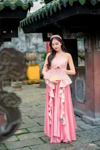 Graceful Woman in Pink Dress Amidst Ancient Heritage Charm 1000025280-1