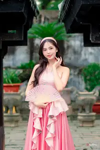 Graceful Woman in Pink Dress Amidst Ancient Heritage Charm 1000025280-6