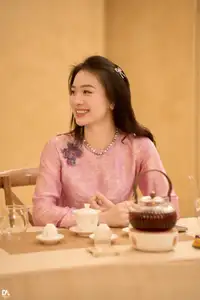 Asian Grace: Vietnamese Woman's Radiant Smile & Elegant Tea Moment-0
