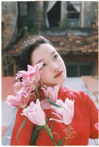 Vintage Ao Dai Beauty: Elegant Vietnamese Woman with Flowers in a Nostalgic Setting-1