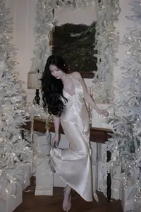Christmas Muse: Elegant Beauty in a Backless Satin Dress by a Sparkling Tree-5