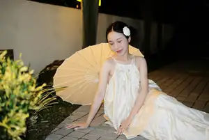 Ethereal Beauty: Woman in White Dress with Elegant Paper Umbrella at Night-1