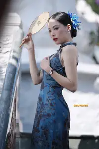 Captivating Asian Beauty: Elegant Woman in Blue Cheongsam with Traditional Fan-0