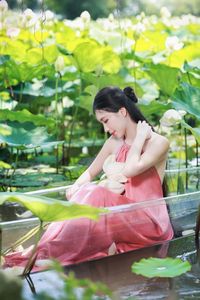 Elegant Vietnamese Girl in Pink Ao Yem by Lotus Pond, Capturing Traditional Beauty and Serenity-12