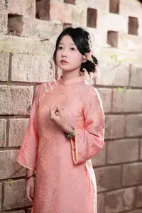 Graceful Asian Young Woman in Traditional Pink Attire: Timeless Beauty by an Ancient Wall-0
