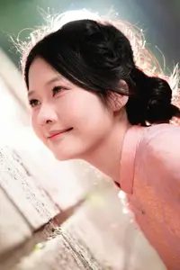 Graceful Asian Young Woman in Traditional Pink Attire: Timeless Beauty by an Ancient Wall-1