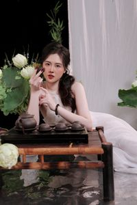 Elegant Vietnamese Girl in White, Embracing Tea Ceremony and Lotus Flowers – Traditional Beauty.-1
