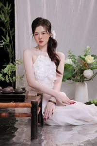Elegant Vietnamese Girl in White, Embracing Tea Ceremony and Lotus Flowers – Traditional Beauty.-0