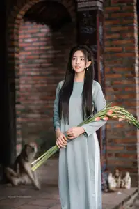 Elegant Ao Dai Beauty: Vietnamese Girl's Grace with Flowers in a Classic Setting-2