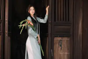 Elegant Ao Dai Beauty: Vietnamese Girl's Grace with Flowers in a Classic Setting-0
