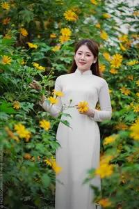 Radiant Youth: Vietnamese Girl in Elegant White Ao Dai Amidst Golden Blooms-16