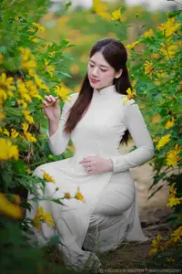 Radiant Youth: Vietnamese Girl in Elegant White Ao Dai Amidst Golden Blooms-6