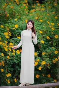Radiant Youth: Vietnamese Girl in Elegant White Ao Dai Amidst Golden Blooms-7