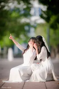 Graceful Vietnamese Girl in Elegant White Ao Dai with Sweet Finger Heart Gesture-3