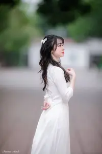 Graceful Vietnamese Girl in Elegant White Ao Dai with Sweet Finger Heart Gesture-2