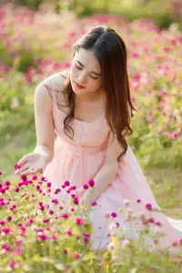 Serene Beauty: Young Woman in Pink Dress Amidst a Vibrant Flower Field-0