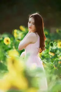 Serene Beauty: Young Woman in Pink Dress Amidst a Vibrant Flower Field-4