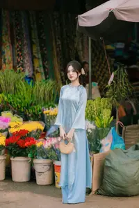 Traditional Vietnamese Beauty: Graceful Girl in Blue Ao Dai with Fresh Flowers-12