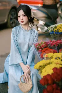 Traditional Vietnamese Beauty: Graceful Girl in Blue Ao Dai with Fresh Flowers-2