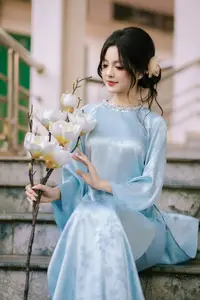Traditional Vietnamese Beauty: Graceful Girl in Blue Ao Dai with Fresh Flowers-5
