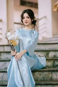 Traditional Vietnamese Beauty: Graceful Girl in Blue Ao Dai with Fresh Flowers-15