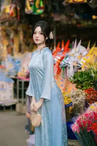 Traditional Vietnamese Beauty: Graceful Girl in Blue Ao Dai with Fresh Flowers-11