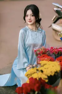 Traditional Vietnamese Beauty: Graceful Girl in Blue Ao Dai with Fresh Flowers-0
