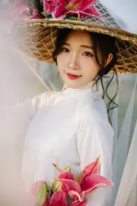 Discover the captivating grace of a Vietnamese woman in a flowing white Ao Dai and traditional conical hat-14