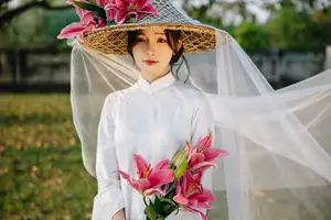 Discover the captivating grace of a Vietnamese woman in a flowing white Ao Dai and traditional conical hat-22