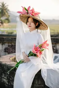 Discover the captivating grace of a Vietnamese woman in a flowing white Ao Dai and traditional conical hat-18
