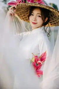 Discover the captivating grace of a Vietnamese woman in a flowing white Ao Dai and traditional conical hat-8