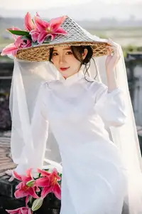 Discover the captivating grace of a Vietnamese woman in a flowing white Ao Dai and traditional conical hat-6